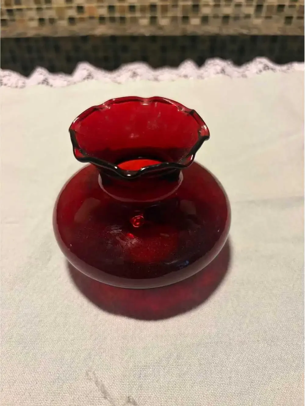 This is a mid-20th century Anchor Hocking Royal Ruby red glass ruffled bud vase.